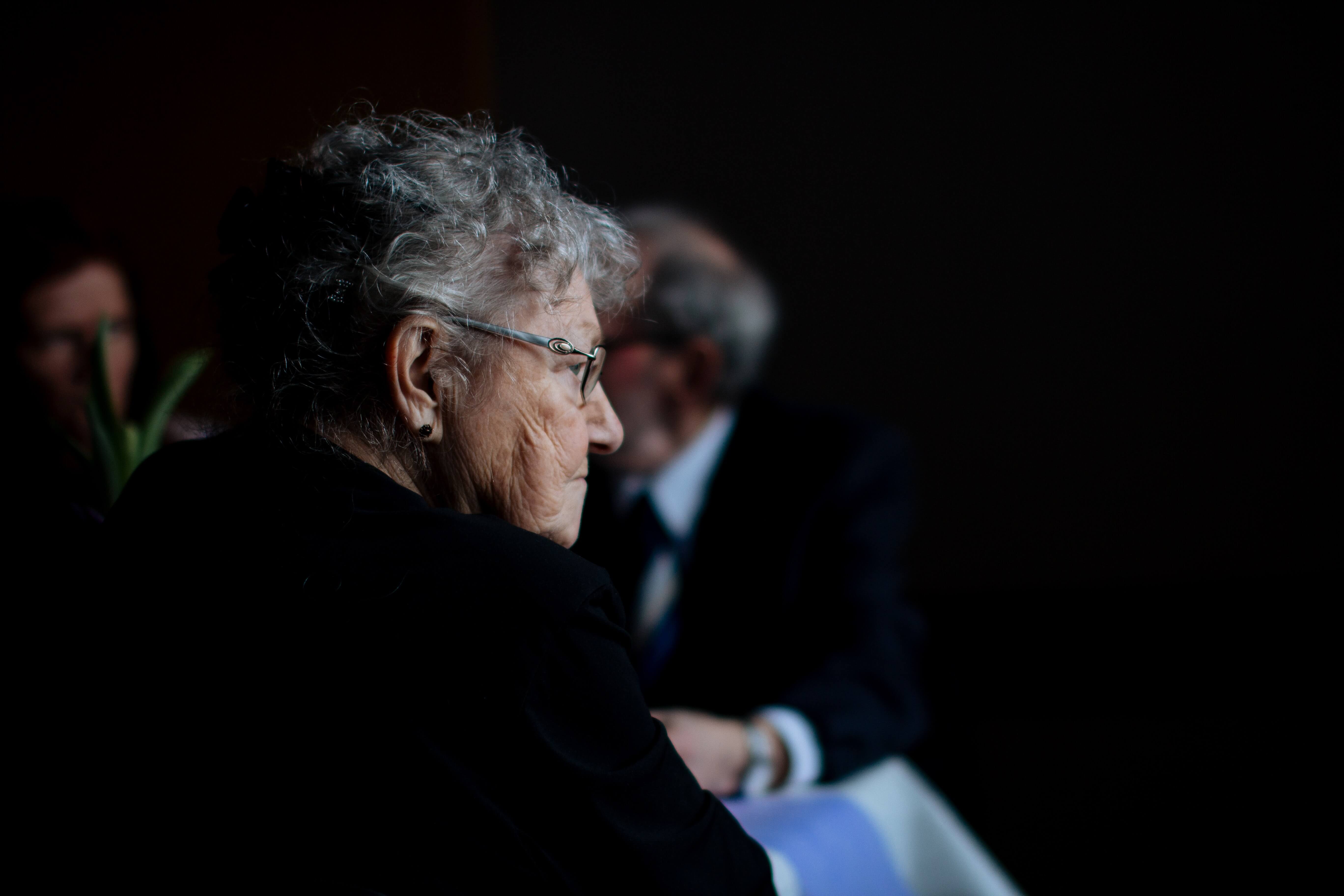 elderly lady sitting on a room