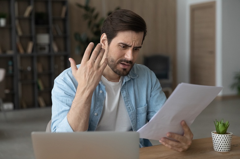 Frustrated person looking at paperwork