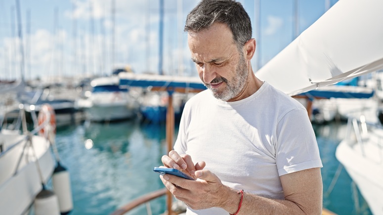 Man on phone near a boat